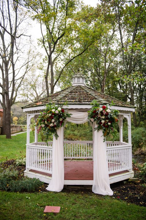 Burgundy, blush, red, greenery, roses, dahlias, rustic chic wedding, gazebo drapery, floral corner pieces