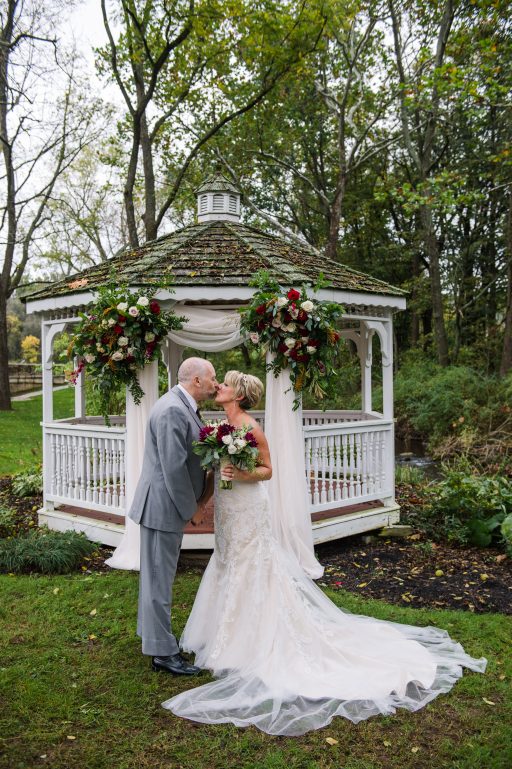 Burgundy, blush, red, greenery, roses, dahlias, rustic chic wedding, gazebo drapery, bride and groom