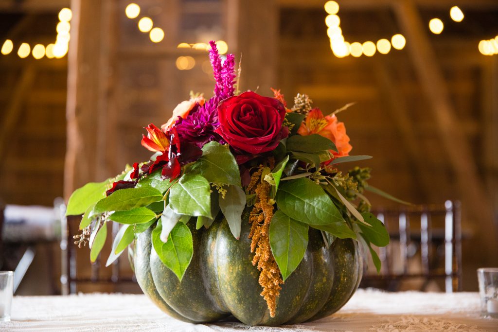 Fall wedding, red, green, yellow, pink florals, dahlias pumpkin centerpiece