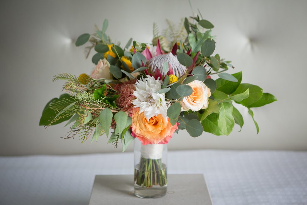 Fall, wedding, secret garden, vintage, viney, blush, peach, muted orange, roses, spray roses, king protea, greenery, birch, dahlias, bridal bouquet.