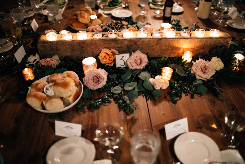 Summer wedding, natural, greenery, light, fresh, peonies, juliet roses, cream, pink, blush, reception, centerpiece. wood slab, candles, greenery, roses.