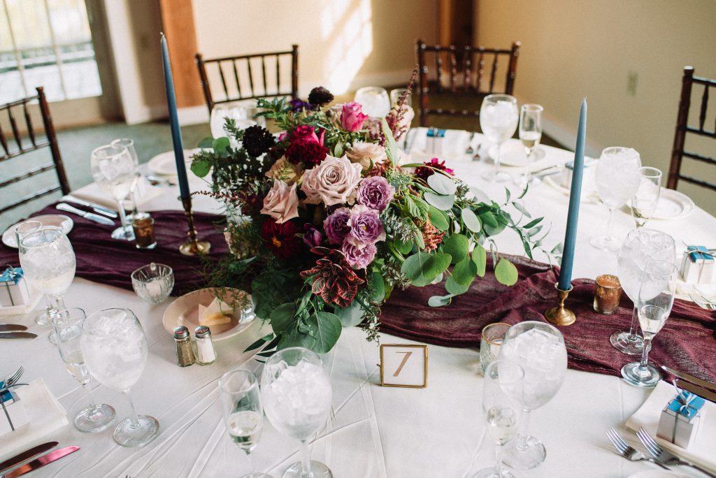 Whimsical, fall, autumn, jewel tones, gardeny, greenery, purples, blues, organic, wedding, centerpieces, taper candles.