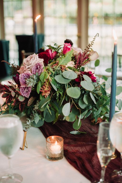 Whimsical, fall, autumn, jewel tones, gardeny, greenery, purples, blues, organic, wedding, centerpiece.