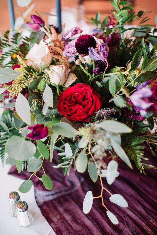 Whimsical, fall, autumn, jewel tones, gardeny, greenery, purples, blues, organic, wedding, centerpiece.