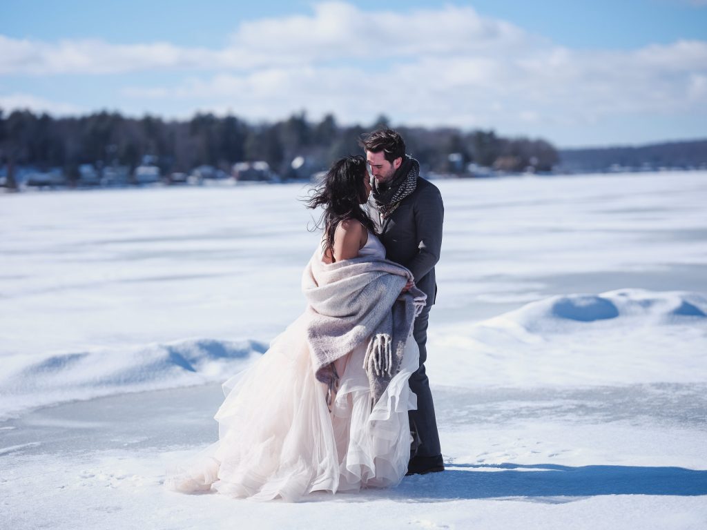 Ice wedding, ice dinner, tule bridal skirt, blush, burgundy, brown, dried florals, winter, frozen lake, styled shoot, bride and groom.