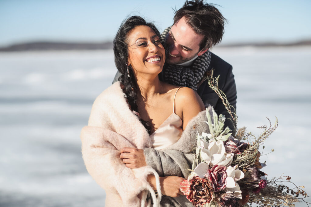 Ice wedding, ice dinner, tule bridal skirt, blush, burgundy, brown, dried florals, winter, frozen lake, styled shoot, bride and groom.