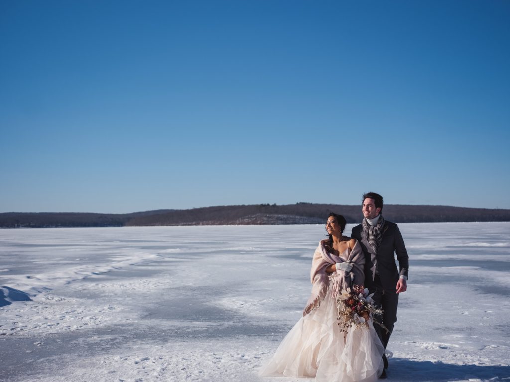 Ice wedding, ice dinner, tule bridal skirt, blush, burgundy, brown, dried florals, winter, frozen lake, styled shoot, bride and groom, bridal bouquet.