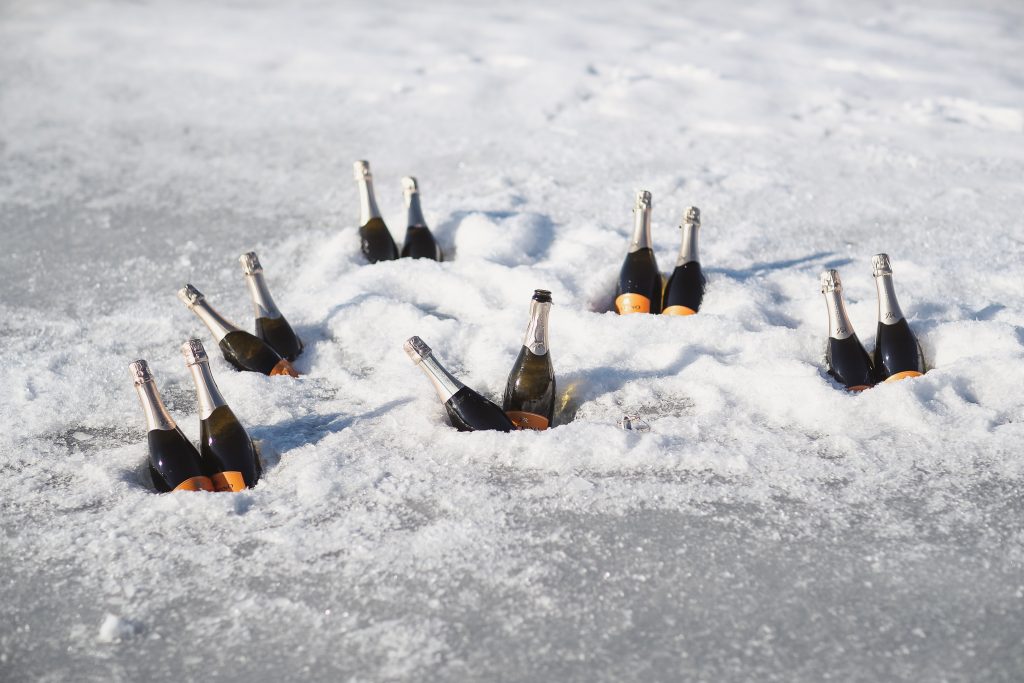 Ice wedding, ice dinner, tule bridal skirt, blush, burgundy, brown, dried florals, winter, frozen lake, styled shoot, wine, ice.