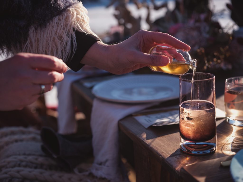 Ice wedding, ice dinner, tule bridal skirt, blush, burgundy, brown, dried florals, winter, frozen lake, styled shoot, cocktail.