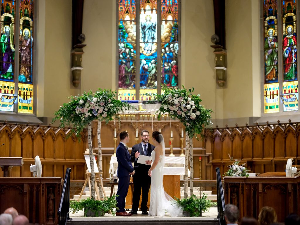 warm, loving, striking and fashionable, artistic, fall wedding, navy, slate bluish, pewter, blush, cream, greenery, texture, botanical, asymmetrical, ceremony, birch chuppah, floral corner pieces.