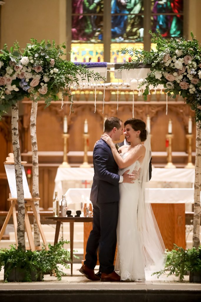 warm, loving, striking and fashionable, artistic, fall wedding, navy, slate bluish, pewter, blush, cream, greenery, texture, botanical, asymmetrical, ceremony, birch chuppah, floral corner pieces.