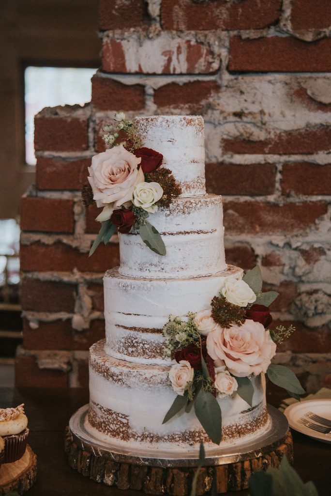 Rustic, country, burgundy, white, burlap, beige, roses, dahlias, spray roses, cake.